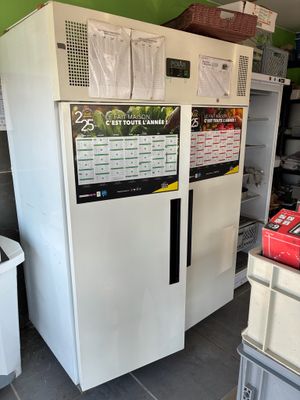 a refrigerator that has a lot of items on the top of it
