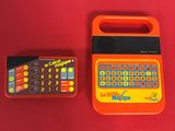 a small calculator and a remote on a red surface