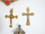 three crosses hanging on a wall next to a mirror