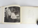 an open book with a black and white photo on it