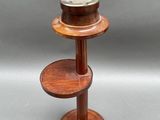 a small wooden table with two shelves on it