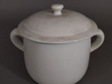 a white pot with a lid sitting on a table
