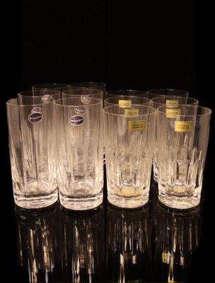 six glasses are lined up in a row on a black surface