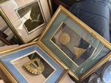 two framed pictures of a clock and a picture of a crown on a table