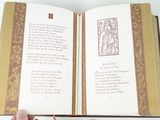 a person holding a book open with a picture of jesus on it