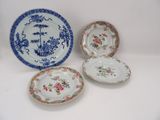 three plates with floral designs on them sitting on a white surface