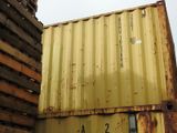 a yellow container sitting on top of a wooden pallet