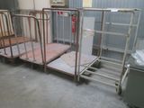 many metal beds in a room with a metal gate