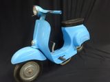 a blue scooter that is sitting on a black background