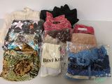 many bags of clothes that are sitting on a table