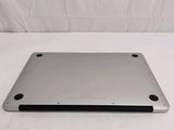 the back of a silver laptop computer sitting on a white surface
