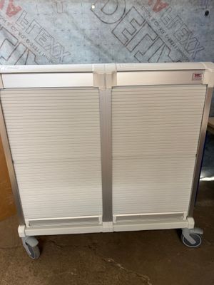 a white cabinet that is on wheels in a room
