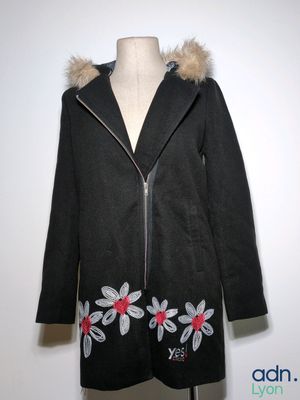 an image of a black coat with flowers on it on a mannequin