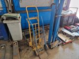a blue cart and a yellow hand truck in a garage