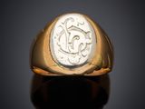 an image of a gold ring with a roman coin in the center