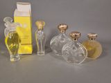three bottles of perfume sitting next to each other on a table