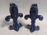 two blue vases that are sitting on a table