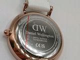 a close up of a watch on a white surface