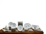 a wooden table with a bunch of plates and bowls on it