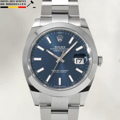 Les cadrans bleus d'une montre Rolex sont visibles sur le bracelet.