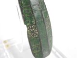 a close up of a green bracelet on display