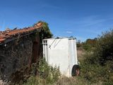 a small building that is sitting in the middle of a field