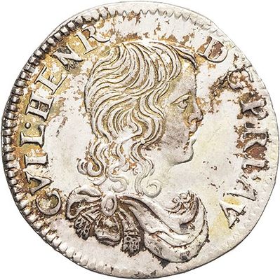 a silver coin with a woman ' s head on it