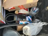 a box of items in the trunk of a car