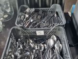 two baskets of silver spoons and spoon spoons on a table