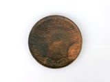 a close up of a penny on a white surface with a white background