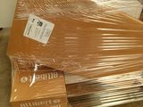 a pile of boxes wrapped in plastic on the floor