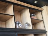 a shelf with jars and jars on it in a kitchen