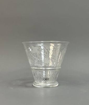 a glass vase with a design on it on a table