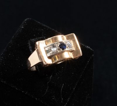 a close up of a gold ring with a blue stone