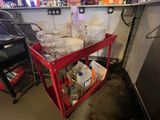 a red cart filled with dishes and glasses in a room