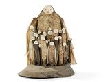 a sculpture of a group of people standing on a rock