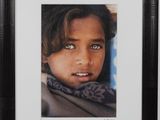 portrait of a young girl with blue eyes in a black frame