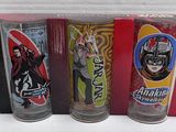 three shot glasses in a red box with stickers on them
