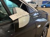 a sign on the side of a car that is parked in a parking lot