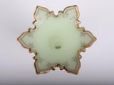 a white and gold brooch with a flower on it