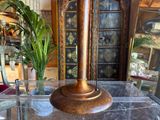 a glass table with a vase on it and a clock on it