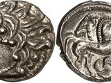 a silver coin with an image of a horse on it
