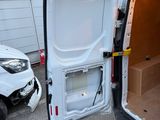a white van with the door open in a parking lot