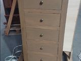 a small chest of drawers sitting on a pallet