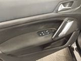 the interior of a car with the door open and the driver ' s seat down