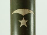 someone is holding a small metal object with a star on it