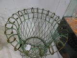 a green wire basket that is sitting on a table