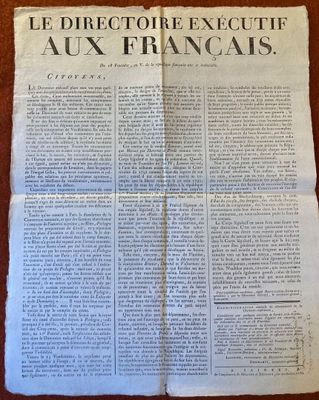 un vieux journal posé sur une table, sur laquelle se trouve un bout de papier