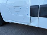 a white van that has been vandalized by a police officer