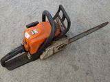 a chainsaw sitting on the ground on the ground